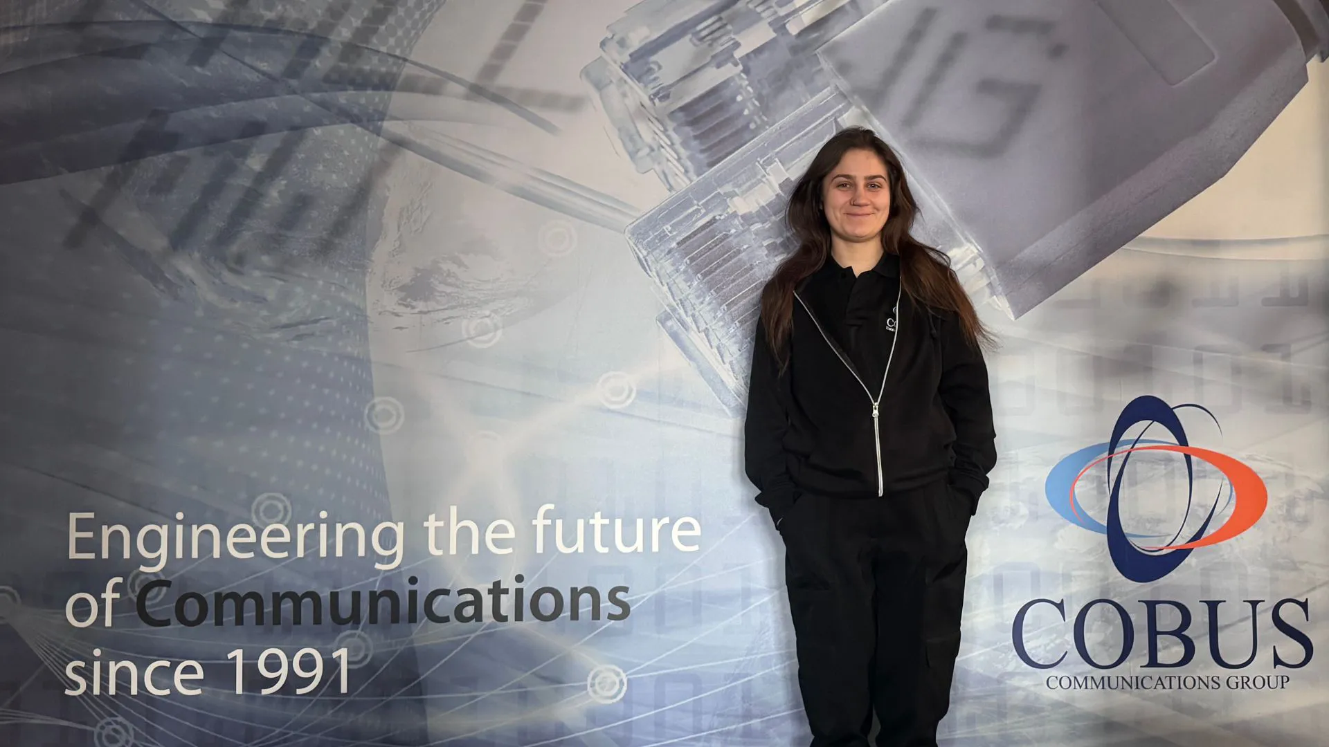 Woman in front of company graphic
